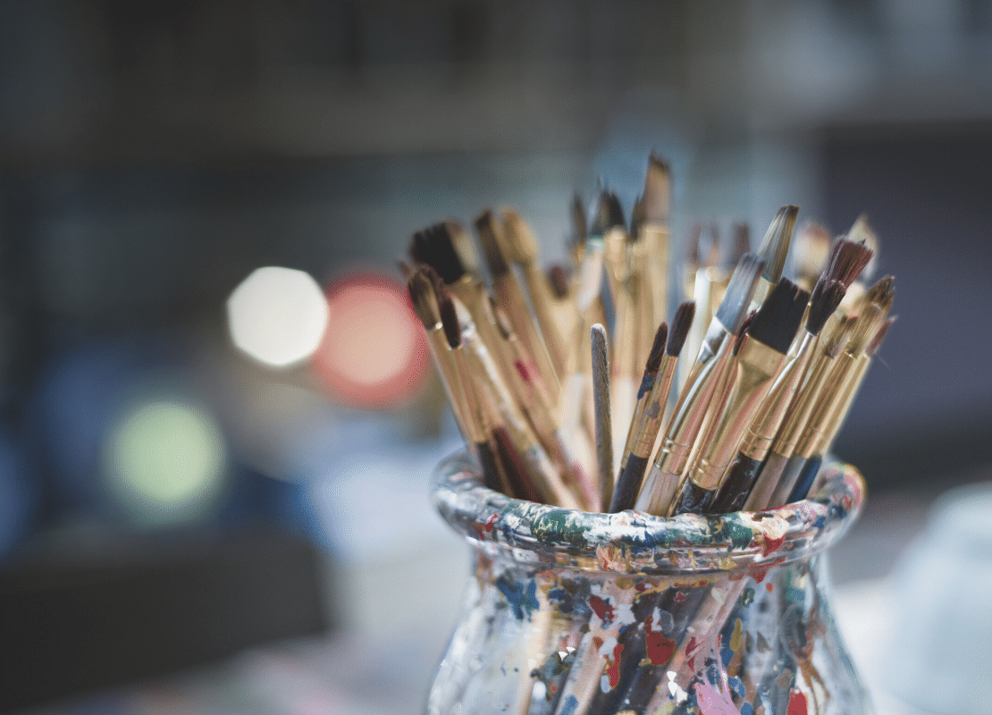 How to be a creative genius at work. Pot of paints and brushes