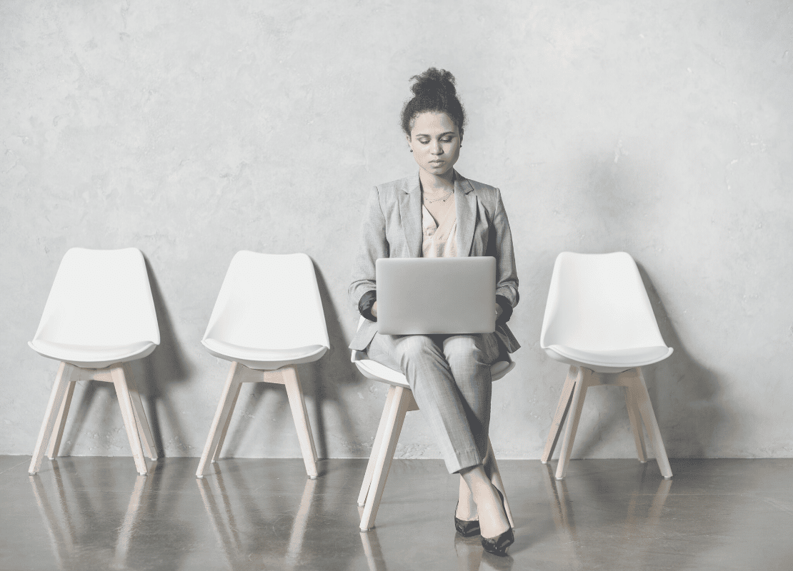 Career transitions for Executive Assistants. Woman sitting on chair with laptop